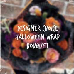 Halloween bouquet with orange and pink flowers wrapped in dark paper