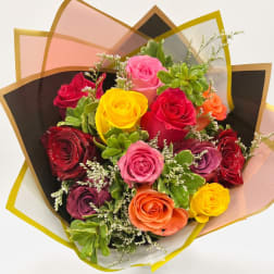 Bouquet of multicolored roses wrapped in translucent paper