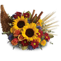 Sunflowers and mixed fall flowers in a wicker cornucopia basket