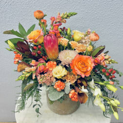Colorful mixed flower arrangement in a round vase