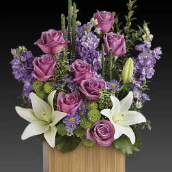 Purple roses and white lilies in a wooden box