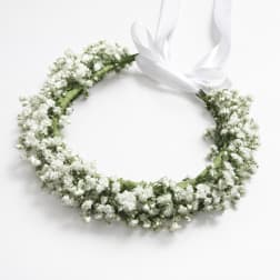 White floral wreath with a satin ribbon bow