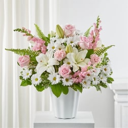 Pink roses and white lilies in a white vase