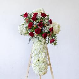 Red roses and white hydrangeas arranged on a standing easel display
