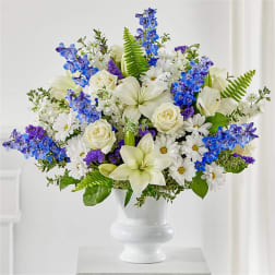 White and blue floral arrangement in a white vase