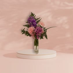 Pink and purple bouquet in a clear glass vase