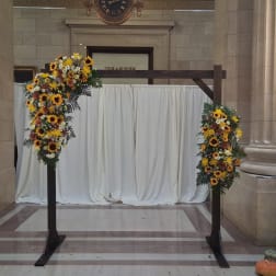Sunflower floral arch with white daisies on a wooden frame