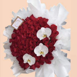 Red rose bouquet with white orchid blooms and white wrapping