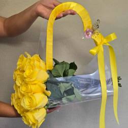 Yellow rose bouquet in a clear handbag-style wrap with ribbon