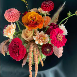 Mixed bouquet with dahlias, roses, and bright orange ranunculus