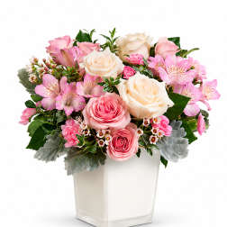 Pink and white rose bouquet in a square glass vase