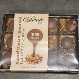 Box of pecan snapper milk chocolates in plastic tray
