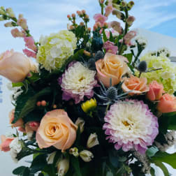 Bouquet of peach roses, pink snapdragons, and white-purple chrysanthemums