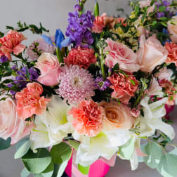 Mixed bouquet of pink, white, and purple flowers in a vase