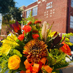 Bright mixed bouquet with orange and yellow roses and a large chrysanthemum