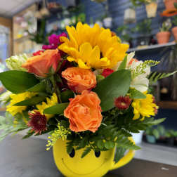 Mixed bouquet in a yellow smiley-face mug