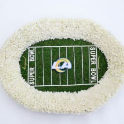 White floral football field arrangement with a Super Bowl logo in the center