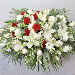 White and red floral casket spray with lilies and roses