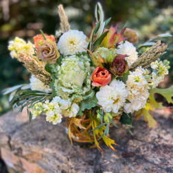 Mixed bouquet of white and peach flowers in a glass vase
