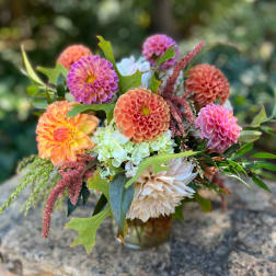 Mixed bouquet of dahlias and hydrangeas in a glass vase