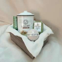 Gift basket with candles, soaps, and bath items in a wooden tray
