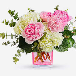 Pink peonies and white hydrangeas in a pink glass vase