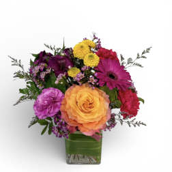 Colorful mixed bouquet in a square glass vase