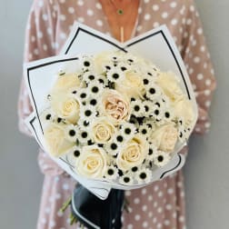 Bouquet of cream roses and white daisies wrapped in white paper
