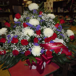 Large bouquet of red roses, white chrysanthemums, and purple filler flowers with a ribbon