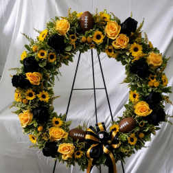 Football-themed floral wreath with yellow roses and sunflowers