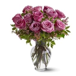 Bouquet of purple roses in a clear glass vase