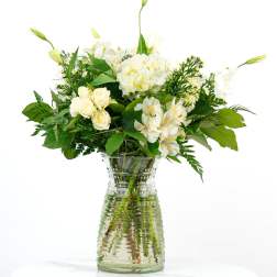 White flowers arranged in a clear glass vase