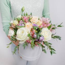 Handheld bouquet of white and pastel roses with pink alstroemeria