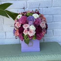 Pink, purple, and white rose bouquet in a lavender box