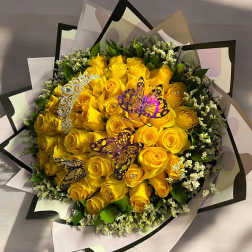 Bouquet of yellow roses with butterfly decorations and decorative wrap