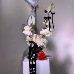 White roses with an anthurium and silver heart balloon on a pedestal