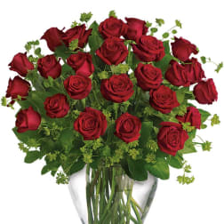 Red roses arranged in a clear glass vase