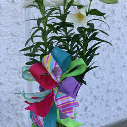 White lilies with a colorful ribbon bow