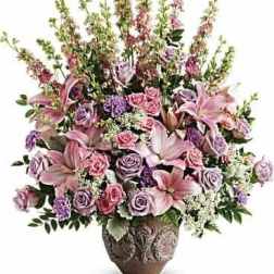 Pink and lavender floral arrangement in a decorative vase