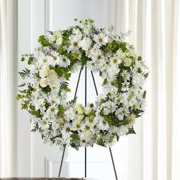 White floral wreath on a standing easel