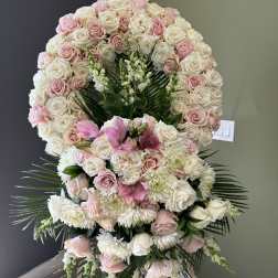 Large standing floral spray of pink and white roses with lilies and chrysanthemums
