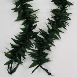Long dark green leaf garland or lei with braided ends on a white background