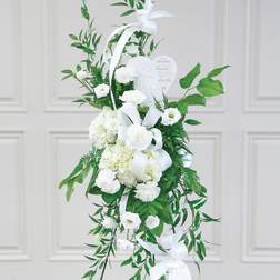 White sympathy standing spray with ribbon and heart plaque