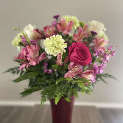 Pink and white mixed bouquet in a burgundy vase