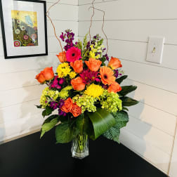 Bright mixed flower arrangement in a clear glass vase