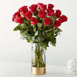 Bouquet of red roses in a tall clear glass vase