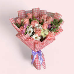 Pink rose bouquet with white daisies in checkered wrap and purple ribbon