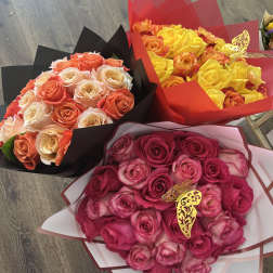 Three rose bouquets in pink, yellow, and peach tones wrapped in colored paper