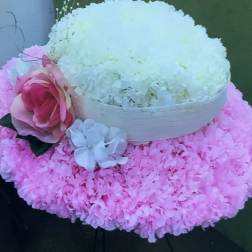 Pink and white floral arrangement with a large rose and hydrangea-like blooms