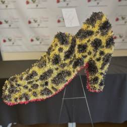 Large floral number-shaped standing arrangement in yellow, black, and pink